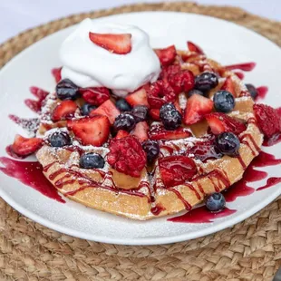 a waffle with strawberries and blueberries