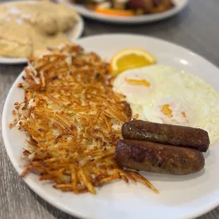 Biscuits and gravy with hash brown, eggs, and sausage links