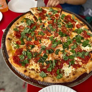 a person cutting into a pizza