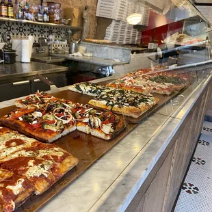 pizzas lined up on a counter