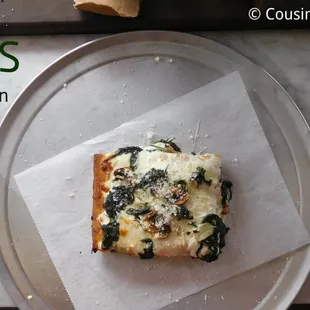 a slice of pizza on a plate