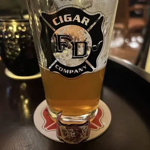 a glass of beer on a coaster