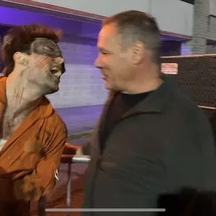 One of the scare actors torturing guests in line.