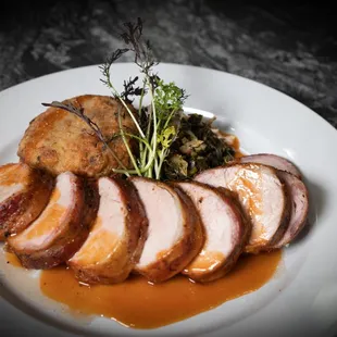 Bacon Wrapped Pork Tenderloin
with black-eyed pea risotto cake, braised collards, roasted grape tomatoes, and BBQ gastrique