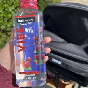  hand holding a water bottle