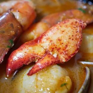 Seafood Bouillabaisse - lobster claw, Kauai prawns, diver scallops, clams in a thai spice lobster broth mounted with brandy butter