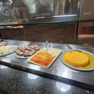 a buffet with a variety of food items