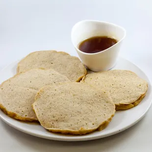 a plate of pancakes and a cup of coffee