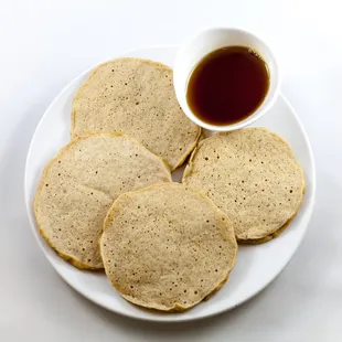 a plate of pancakes with syrup