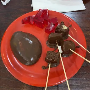 a red plate with chocolate and candies