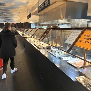 a woman standing in front of a buffet