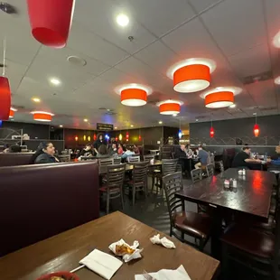 people eating in a restaurant with red lights