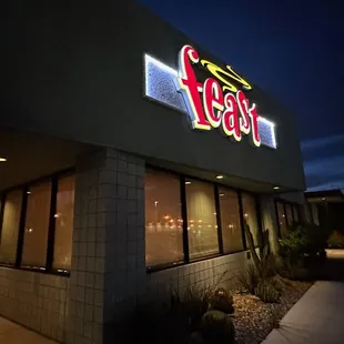 the exterior of a restaurant lit up at night