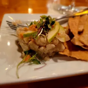 Charred scallop tartare with lemongrass aioli, pear and Marcona almond.  House-made sourdough crackers and microgreens.