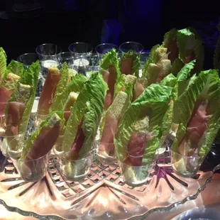 ows a platter of lettuce and bacon wrapped in lettuce