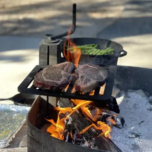 Bone in ribeyes over an open flame... and asparagus