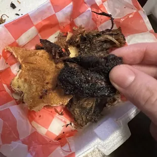 a person holding a piece of food