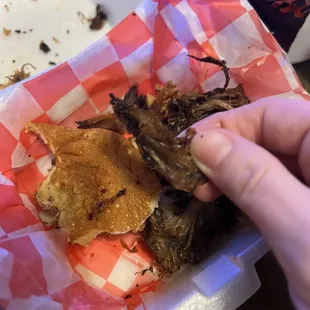 Dried, jerky like pulled pork on a burnt bun.