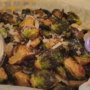 a basket of brussels sprouts and sauce