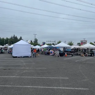 a lot of tents set up in a parking lot