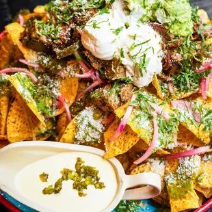 a plate of nachos with sour cream