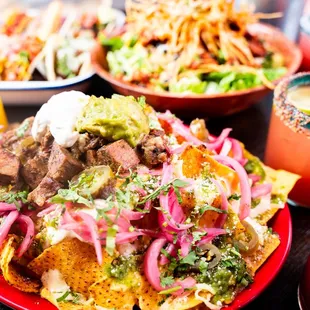 a plate of nachos with beef and onions