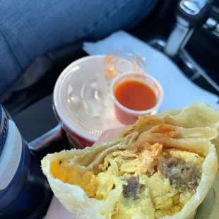 Sausage breakfast burrito with hot sauce in a hotel