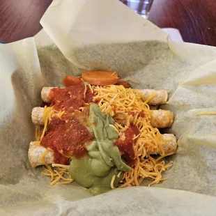 Three roll tacos with guacamole and cheese! Seven bucks.