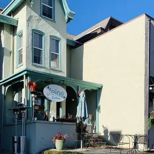  the front of a house with a patio and patio furniture