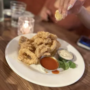 a plate of fried food with dipping sauce