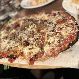 a pizza on a wooden cutting board