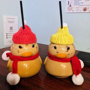 two ceramic snowmen with hats and scarfs