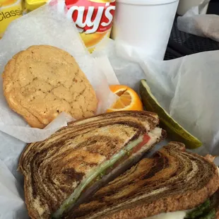 felini&apos;s turkey and pesto sandwich, chips, pickle and white chocolate cookie.