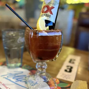 a bloody drink with a bottle of beer