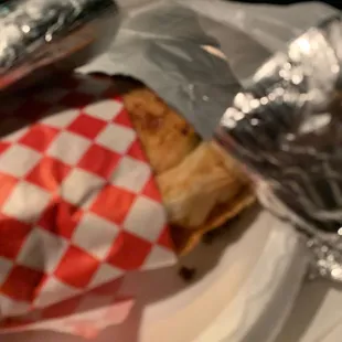 a sandwich wrapped in aluminum foil