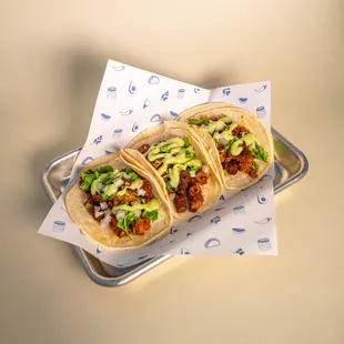 three tacos on a tray
