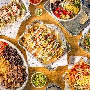 a table full of tacos and mexican food