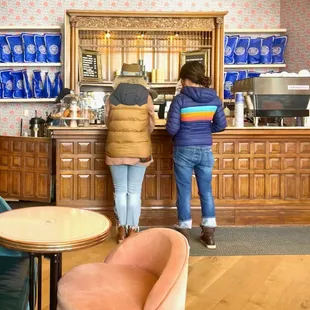two people standing at a counter
