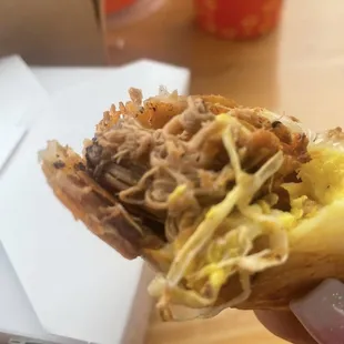 a hand holding a sandwich