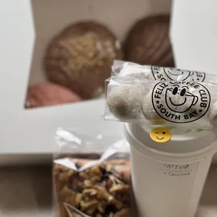 a cup of coffee and a bag of nuts