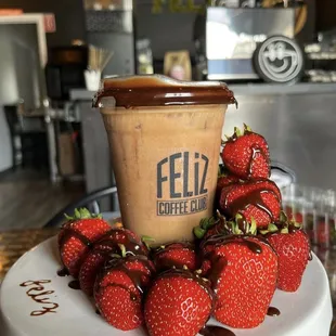 a cup of coffee and strawberries