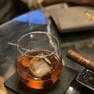 a cigar and a glass of whiskey