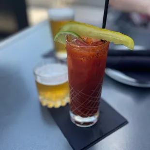 a bloody drink with a slice of lime
