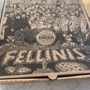 a group of people gathered around a pizza box