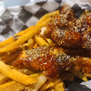 a basket of chicken wings and french fries
