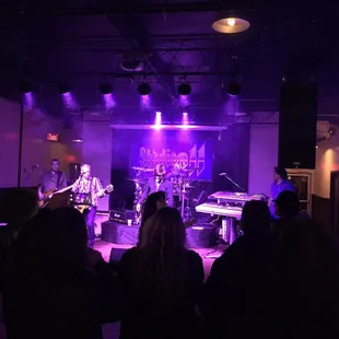 a band performing in a dimly lit room