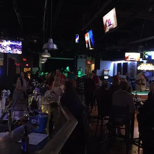 a group of people sitting at a bar