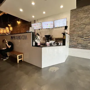 a man sitting on a bench in a coffee shop