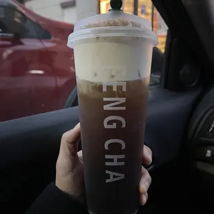 Oolong tea with milk foam and boba