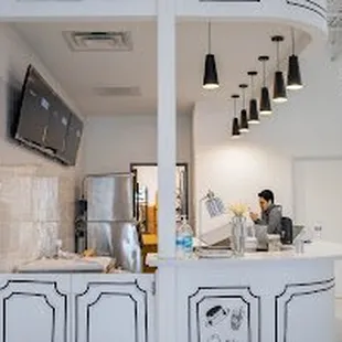 a kitchen with a counter and a tv